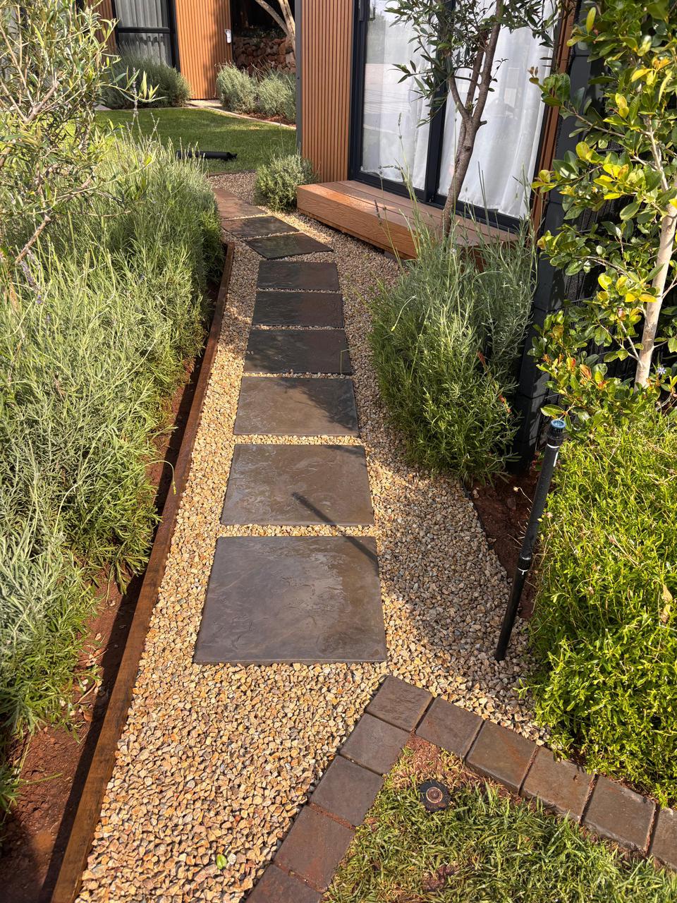 Stepping stone pathway through garden with lavender planting, Cape Town